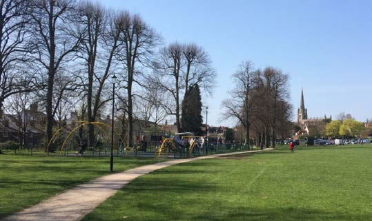 Key view of St Mary’s Church framed with vertical emphasis of mature trees on The Common. Saffron Walden.