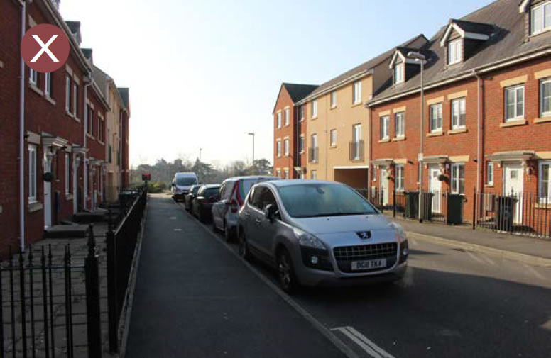 On-street parking without trees or planting.