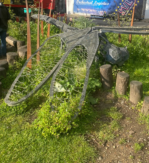 Street art incorporated as informal play space with natural logs creating opportunities for play in addition to seating.