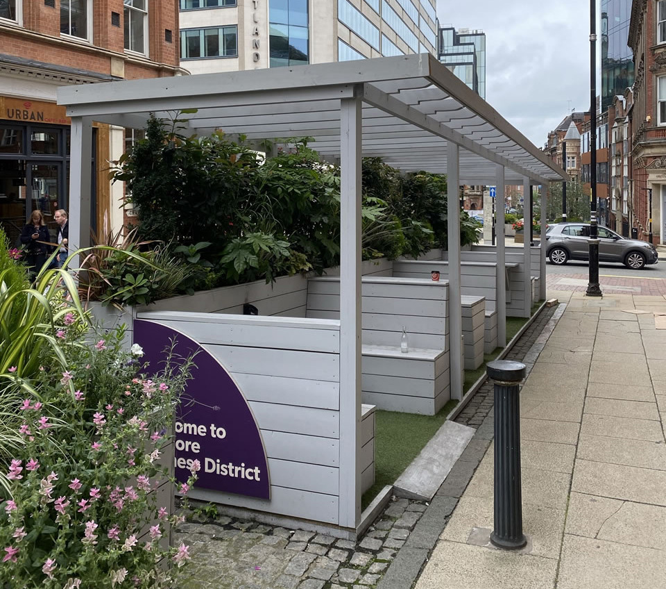 Example of temporary adaptation of parking bays for outdoor community gathering spaces.