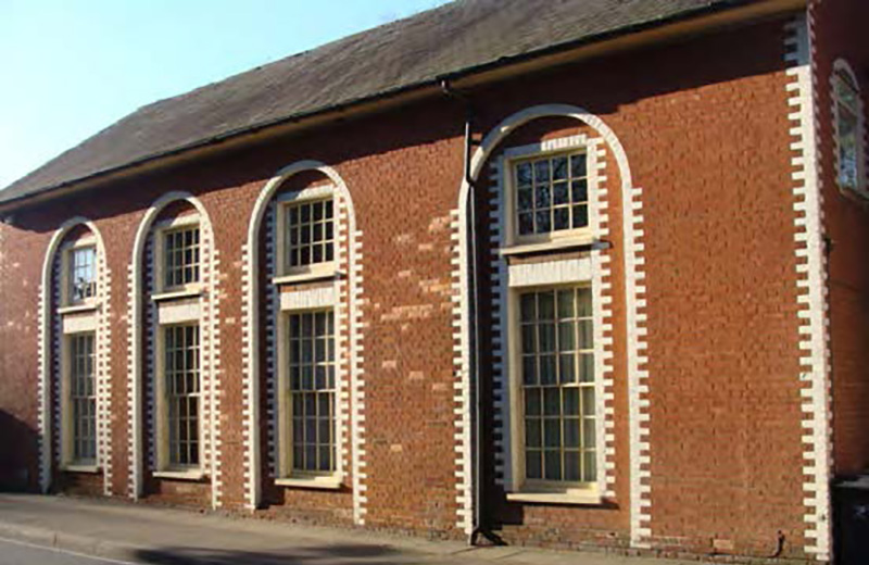 Arched windows and flint wall positively addressing London Road.