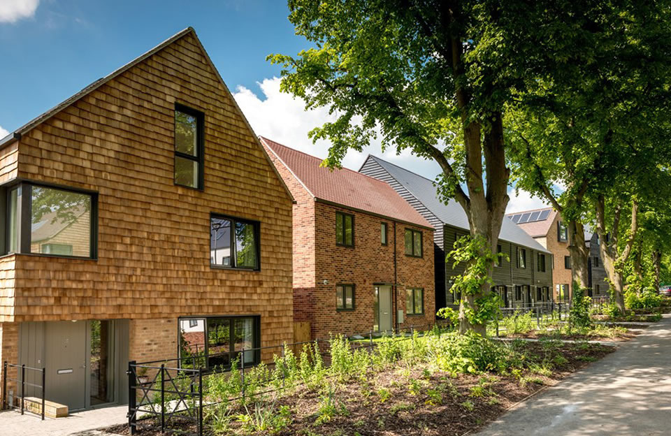 Modern interpretation of barn typology on the Avenue - Black weatherboarding and stone cladding.