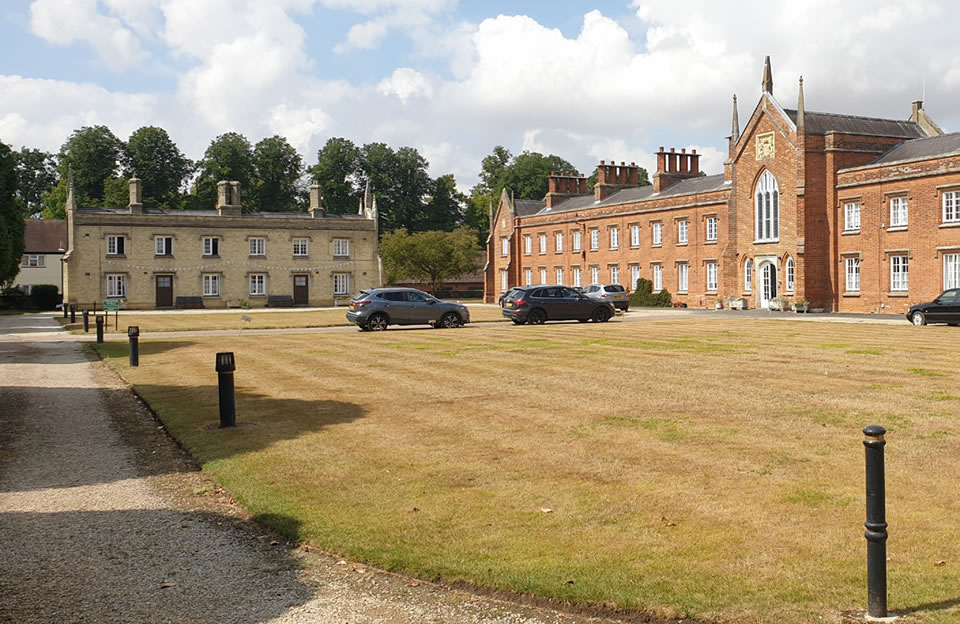 Two storey Almshouses differ in architectural style, while overlooking and enclosing public space in Saffron Walden.