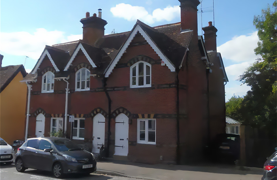 Pleasing terrace of C19 houses with prominant chimneys, elaborate decorative brickwork and patterned bargeboards.