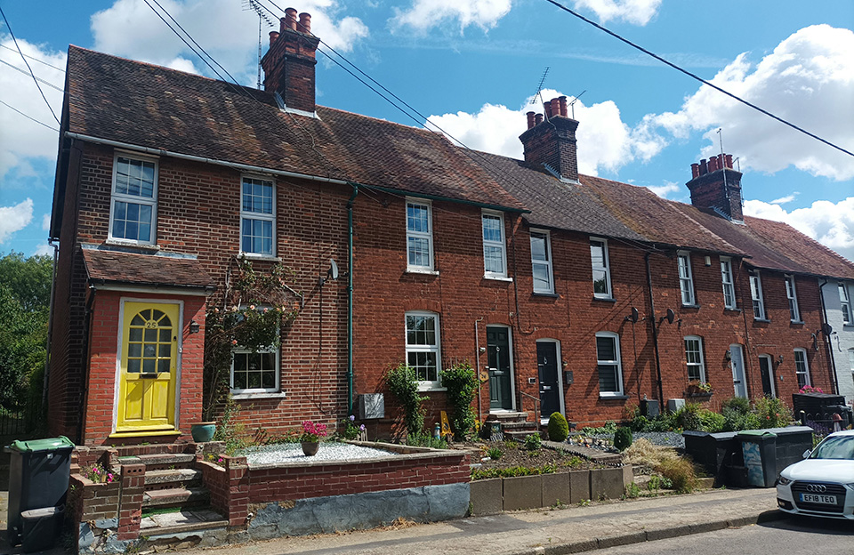 Consistent rooflines of Victorian terraces along Station Road create strong character.