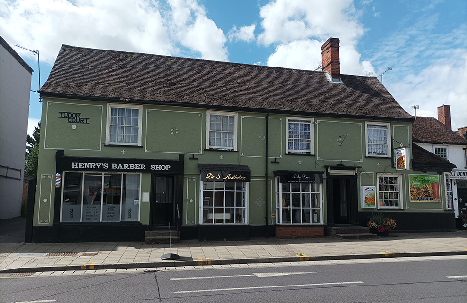 Shops integrated into pargetted and symettrical timber framed semi-detached properties.