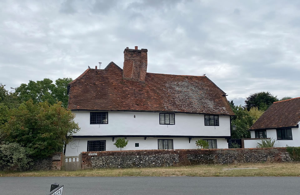 Memorable design - irregular timber framed house shape and stone wall boundary along Bentfield Green.