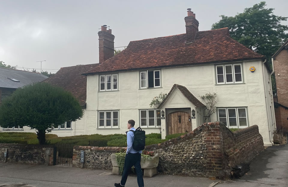 Modest stone wall boundary with peg tiled roof and casement windows on The Porch, Lower Street.