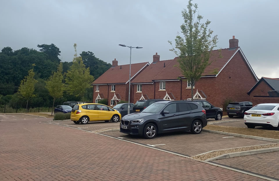 Front parking court within shared space with landscaping detail along Dairy Lane.