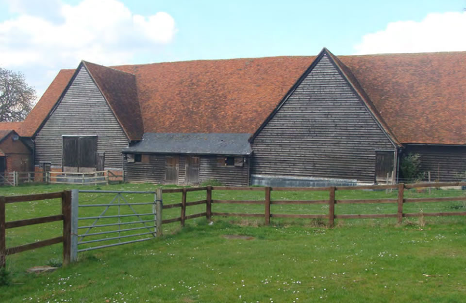 Grade II listed Bury Farm Barn, Felsted, with a restored weatherboarded timber framed and Queen post roof structure.