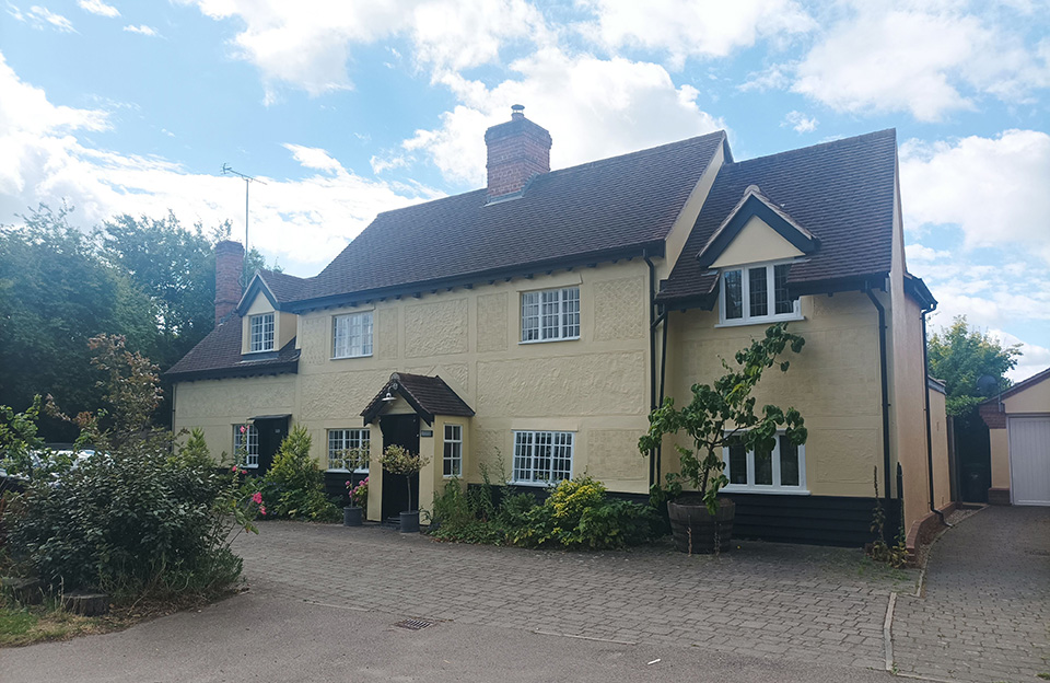 Peg tiled roof, pargetting, dormer windows, central chimeny and black weatherboarding Dunmow Road, Takeley.