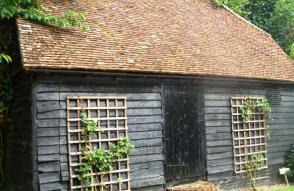 Black weatherboarded barn with peg tiled roof demonstrates character at the smallest scale in Elmdon.