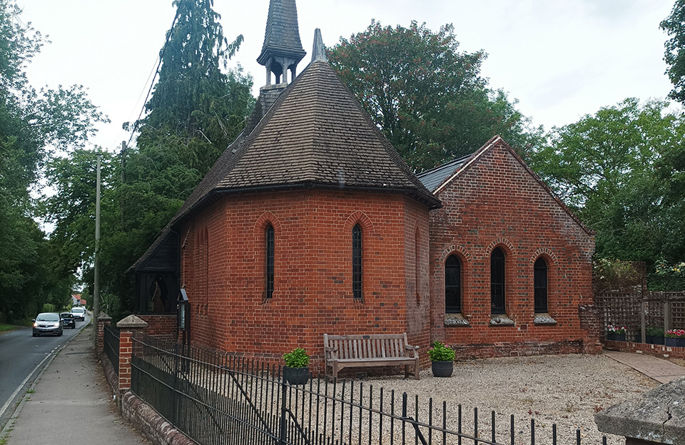 St. James chapel in Sewards End comrpises of a semi-hexagonal apse and fourlegged belfry with fleche.