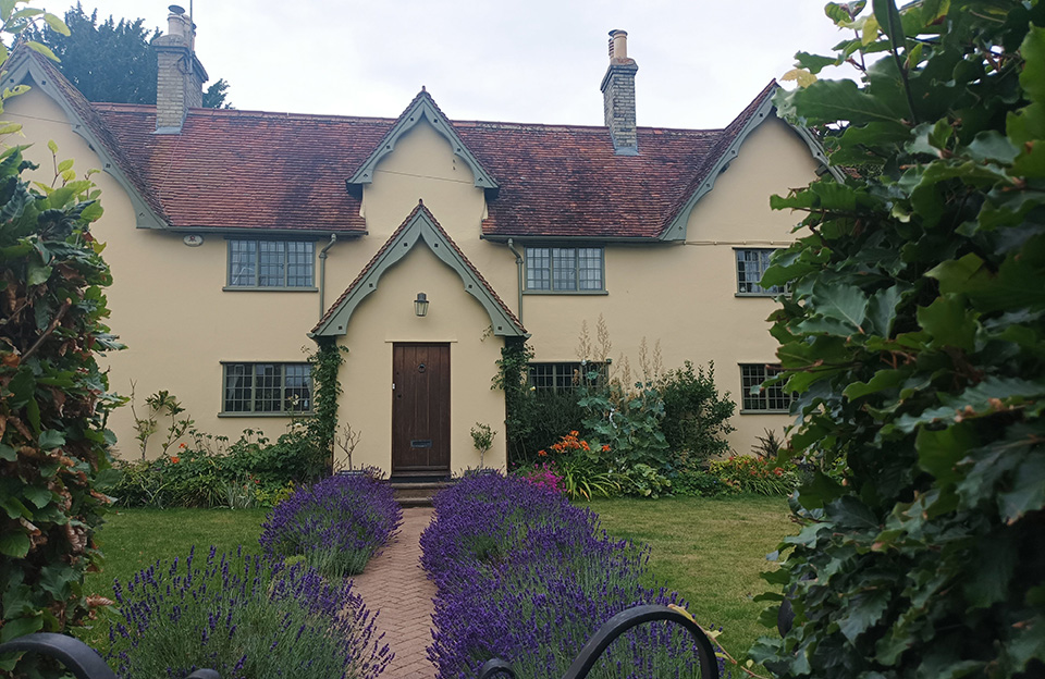 A series of front-gables with symmterical windows and chimney stacks adds an ornate character to this property in Wicken Bonhunt.