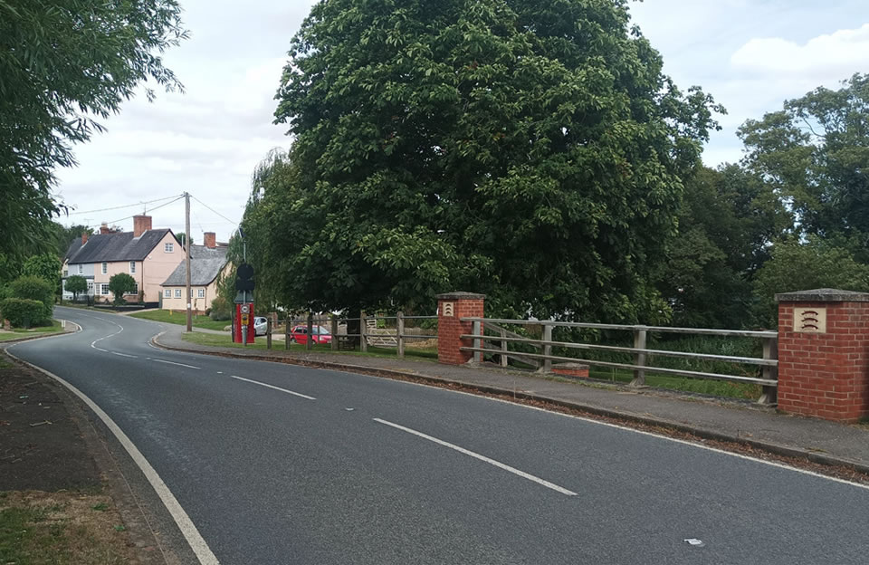 Bridge over the River Pant lined with mature trees creates sense of arrival upon entering Great Sampford.